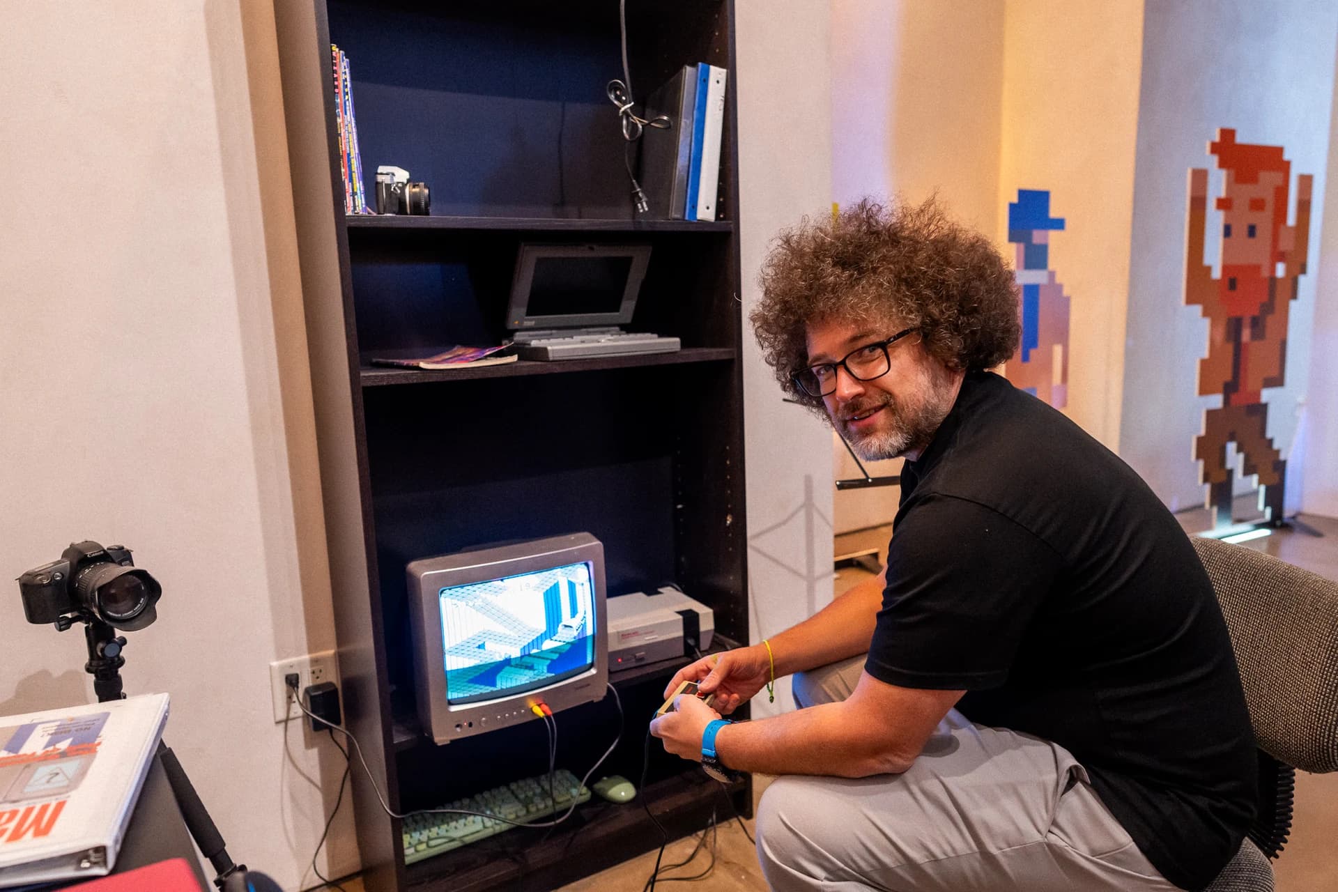 Erick Calderon playing a retro video game at the LIFT exhibition.