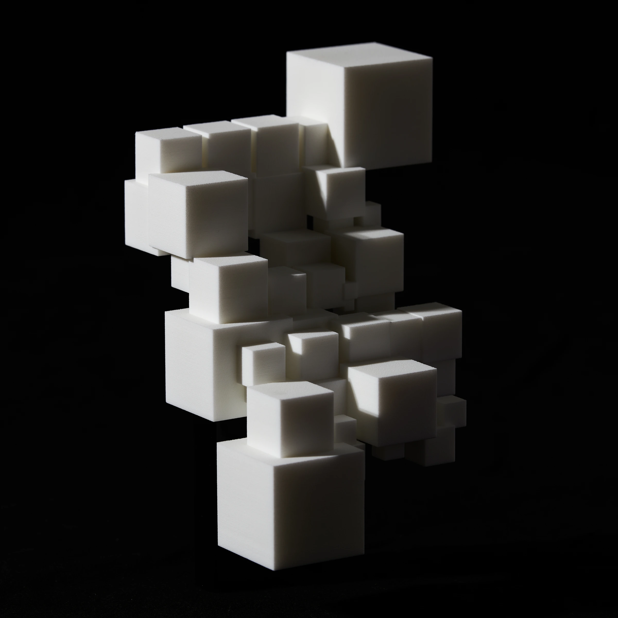 The final opaque white CryptoCube against a black background, showing its fine, sugary surface without colored projection.