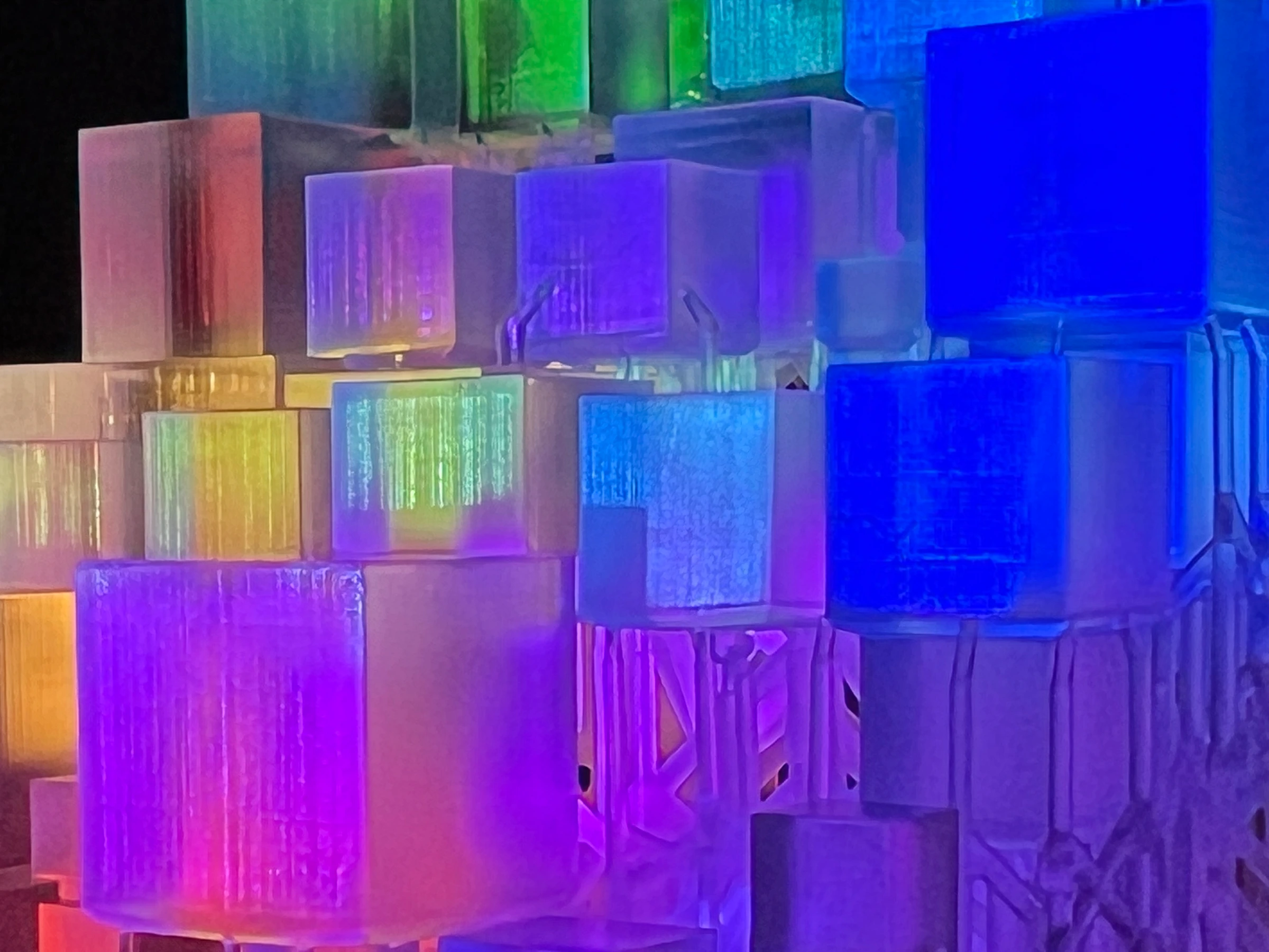 Close-up of projected color passing across the translucent CryptoCube's faces and visible printing layers.